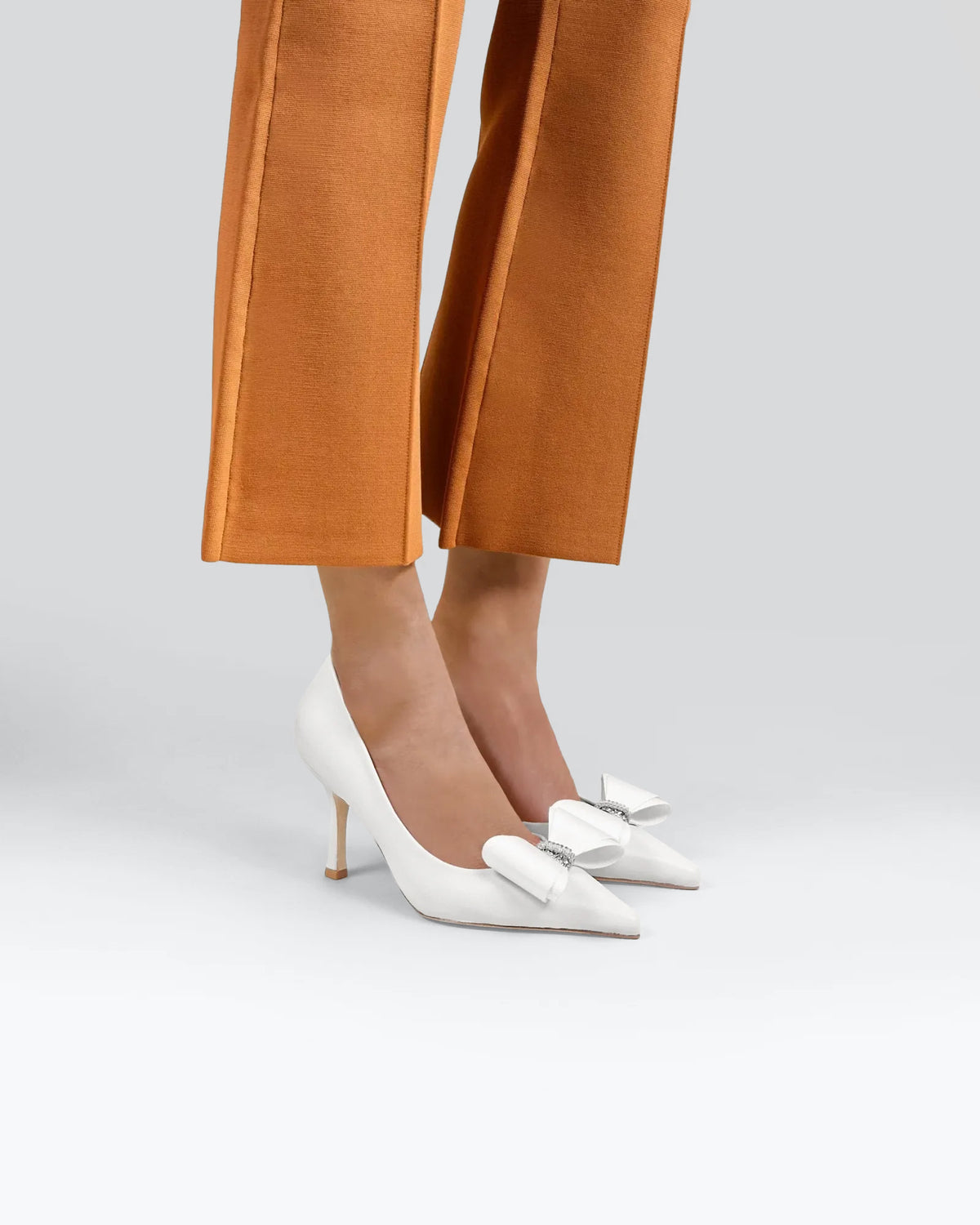 Iris White Leather pointed-toe pumps with bow and rhinestone embellishment