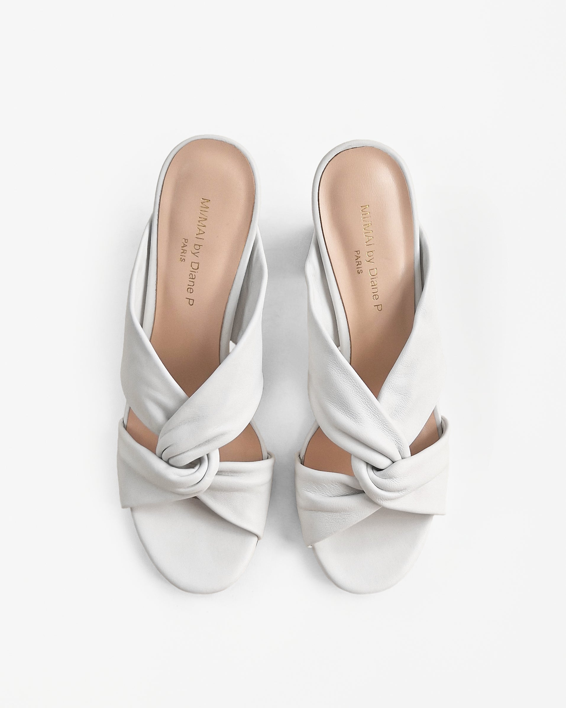 Tamarama White heeled mules by Diane Perreau