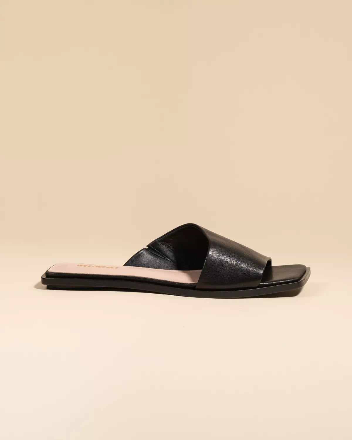 Eero Black flat mule with wide black leather strap